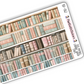 Close up view of vintage themed washi strip sticker sheet with 5 stickers, shown in old vintage bookshelf artwork.