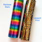 a roll of rainbow stars next to a roll of leopard print